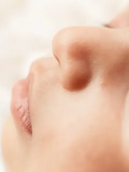 A profile view of a newborn's lips and nose, highlighting their perfect, delicate features.