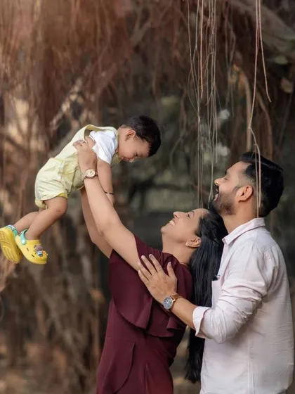 Pure joy as a mother lifts her child into the air during an outdoor family photoshoot. These are the memories that last a lifetime.