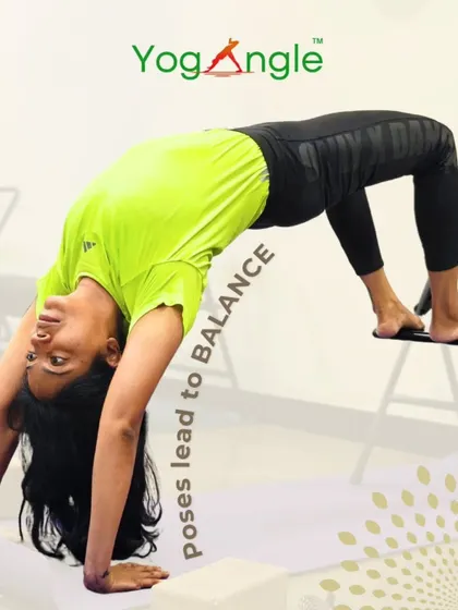 Poses lead to balance. This student demonstrates a variation of bridge pose using a chair, a technique that helps strengthen the back and open the chest while maintaining stability.