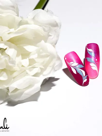 A simple yet elegant swirl design in white and silver on a bright pink ombre base.