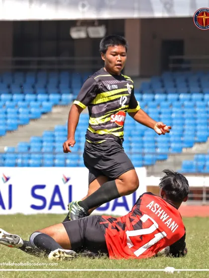 A tough tackle during a B Division match. Our players are trained to be strong and fair in their challenges.