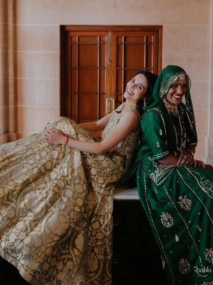 A moment of shared laughter and connection between the bride and a local Rajasthani woman, showcasing the joy of cultural exchange.