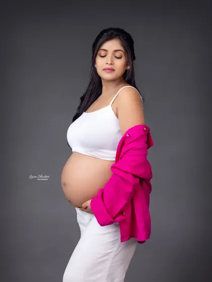 A beautiful bare-bump shot that is both tasteful and modern. The simple styling with the open shirt focuses on the amazing journey of creating life.