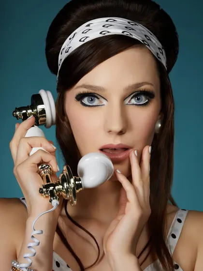 A student's vintage-inspired look, dialing back time with dramatic 60s eyeliner, a bouffant hairdo, and classic polka-dot details.