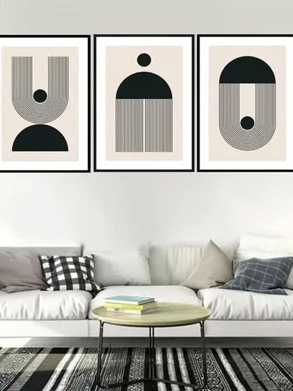 This set of three framed prints features ascetic geometric designs in black and white. The clean lines and minimalist shapes create a sophisticated and modern gallery wall.