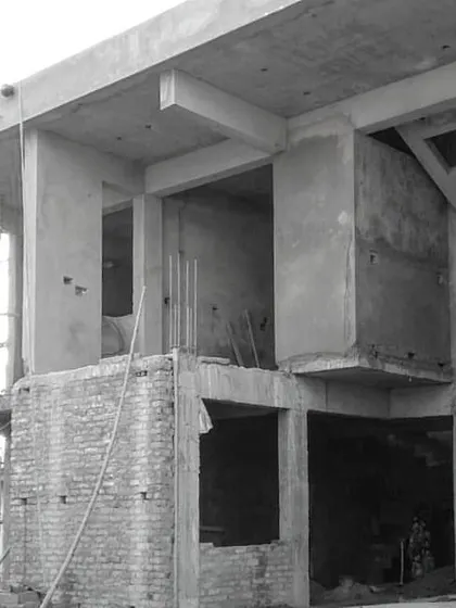 The raw concrete and brick structure of Residence 1 in Lucknow during construction. This image captures the essence of the design, with floating volumes and double-height verandahs creating a sense of scale and openness even in a smaller home.