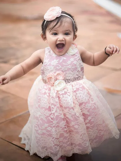 The same happy girl, a different beautiful moment. Her infectious laugh and bright smile are the best accessories for her pink lace dress.