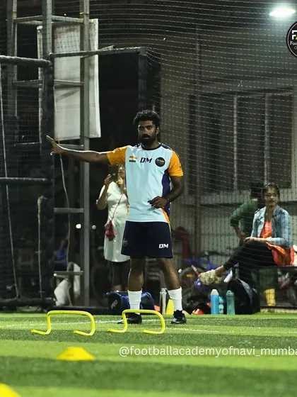 A coach directs a drill, guiding players on their positioning and movement. This hands-on approach ensures everyone is on the right track.