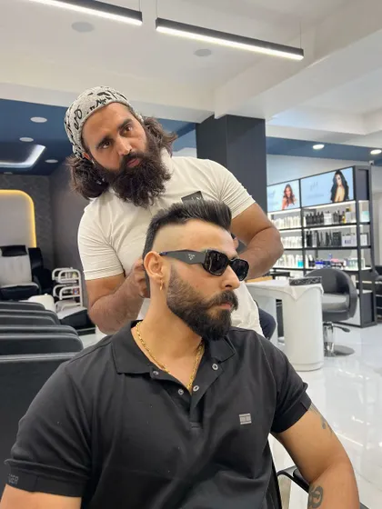 A side profile of a sharp fade in progress. The sunglasses add to the cool factor, but the haircut is the real star of the show.