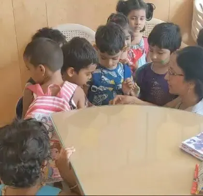 A teacher engages a group of young children during our Holi festivities.