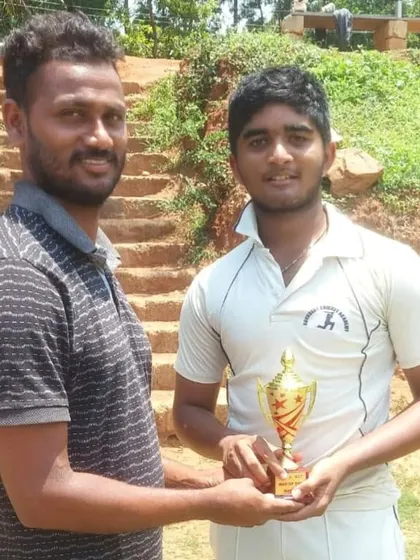 A player receiving the Man of the Match trophy after a 7-wicket victory in the JS Cup U-17.