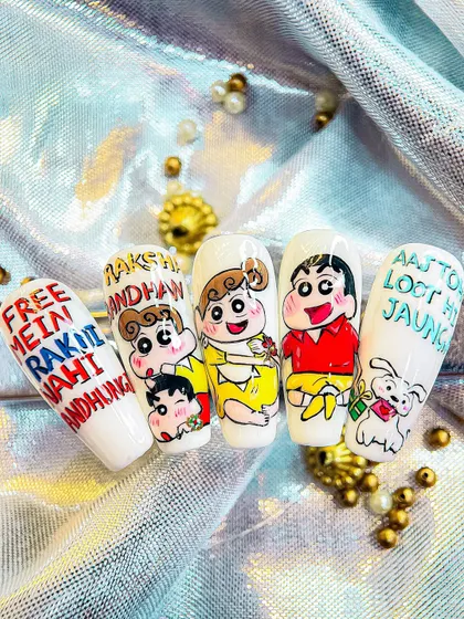A fun and playful Raksha Bandhan nail art design featuring the beloved cartoon characters Shinchan and his sister, complete with funny Hindi phrases.