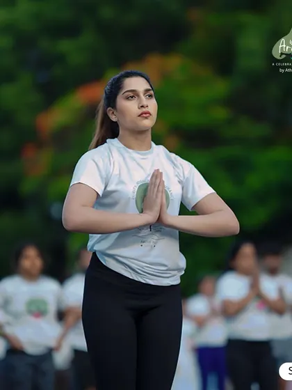 A participant holds Anjali Mudra (prayer hands) during the Yoga Arambha event, her focus embodying the calm and centeredness we cultivate in our practice.