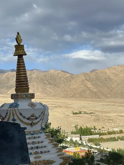 A stupa overlooking the vast, arid landscape of Ladakh. These structures are points of immense peace and spiritual energy, perfect for a moment of quiet meditation.