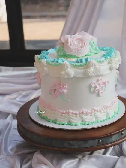 Another angle of the vintage pastel piped cake, showing the intricate details all around.
