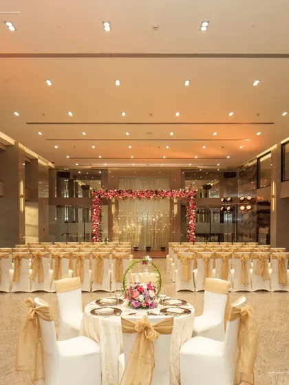 The Cordelia Ballroom set up for an intimate ceremony. This demonstrates how even our grandest space can be transformed to feel warm and personal, with elegant chair covers and a simple floral arch creating a beautiful focal point.