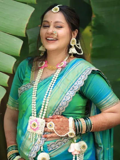 Pure joy and laughter. This mom-to-be is wearing a full set with a floral kamarband and kalire, looking absolutely radiant.