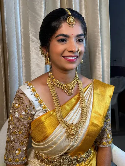 My bride Shanthala, looking radiant for her muhurtham. We went for a classic look with golden shimmery eyes and a bright lip that complements her white and gold silk saree.