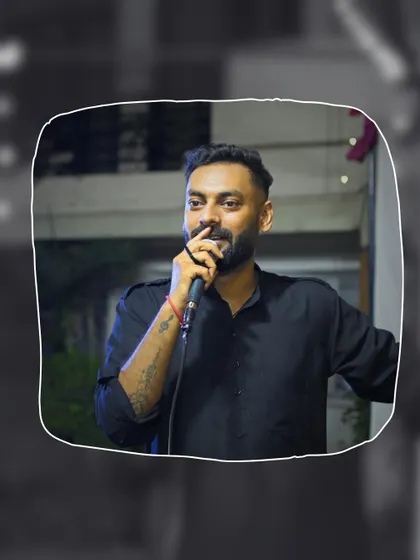 A stylized shot of me on the mic at the Ajnara Pride event. Even in the chaos of a big party, the focus is on delivering a great performance.