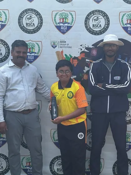 A player poses with his award, flanked by a coach and an official, at the RSCA League.