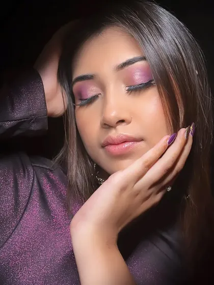 This eyes-closed shot highlights the blending and shimmer of the purple eyeshadow.
