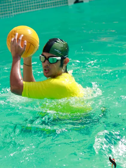 Intense focus during a water polo game, showcasing another exciting activity you can host at our swimming facility.