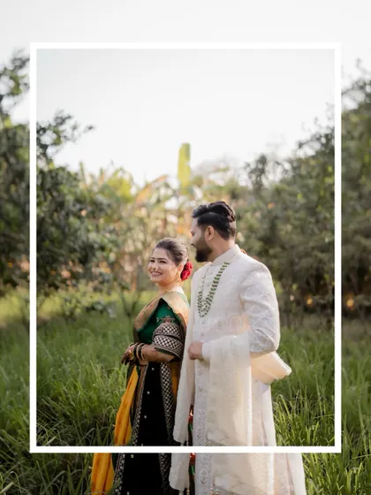 A candid portrait of the couple in a field of tall grass, the bride looking back at the camera with a smile.