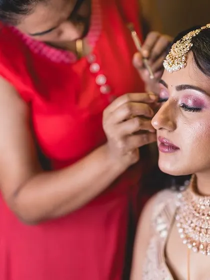 Candid shots of me in action, getting the bride ready for her big day. I take care of both makeup and final draping to ensure every detail is perfect.