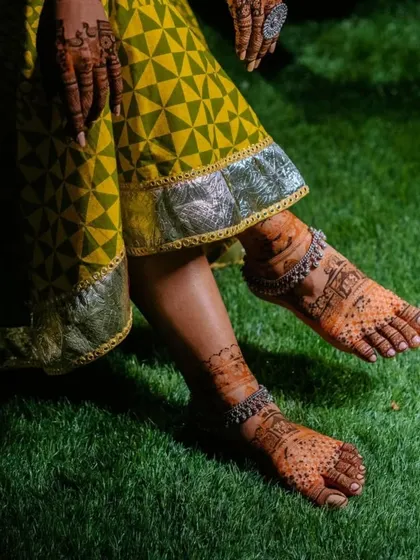 A beautiful photo showcasing the bride's feet with silver anklets over the mehndi. The combination of henna and jewelry is simply timeless.