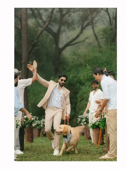 The groom makes his entrance with his best friend, a beautiful golden retriever, by his side. This heartwarming moment shows that family, including the four-legged members, are a key part of the celebration.
