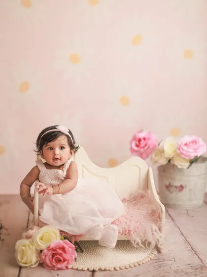 Celebrating six months with a lovely pink daisy-themed setup. I offer a variety of backdrops and props in my studio to create the perfect scene for your baby's half-birthday.