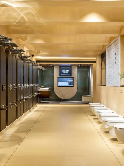 This long-view of the showroom demonstrates how I organize product displays for clarity and impact. The linear arrangement of showerheads and toilets allows for easy comparison, guided by clean sightlines and uniform lighting.