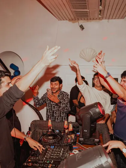 It's not just a solo act. This photo shows the energy of my friends and the crowd right there with me in the DJ booth.