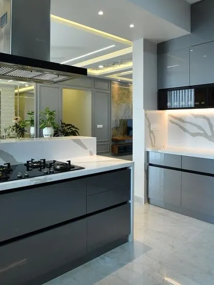 The final executed kitchen, which brings the render to life. The dark grey glossy cabinets, island with a hob, and marble backsplash are perfectly realized, demonstrating our commitment to quality and precision.