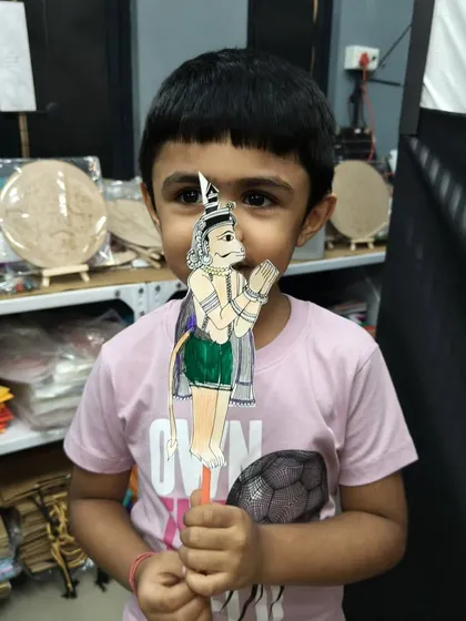 After the show, the kids get to make their own puppets. This young boy is proudly holding up his Hanuman puppet, a tangible memory of his introduction to the world of Indian folk art and storytelling.