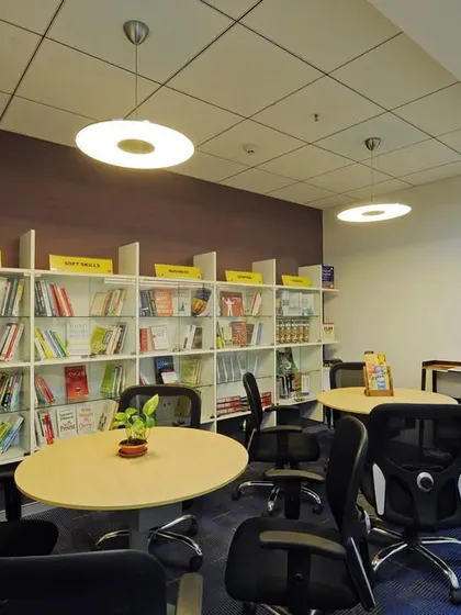 A multi-purpose space that functions as both a lounge and a library, with bookshelves and comfortable seating for reading or informal meetings.