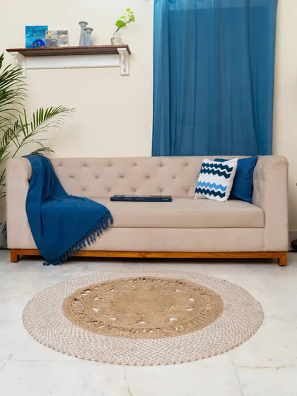 A full view of our custom-upholstered tufted sofa, set against a backdrop of deep blue curtains. This piece combines timeless design with contemporary comfort, serving as the anchor for a serene and stylish living room.