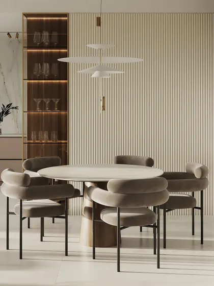 A sophisticated dining concept with a round table and uniquely shaped, plush velvet chairs. The backdrop features a fluted wall and a built-in, illuminated glass cabinet.