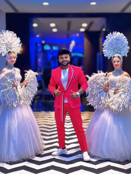 Posing with performers at an event. My outfit is designed to complement the grandeur of the occasion.