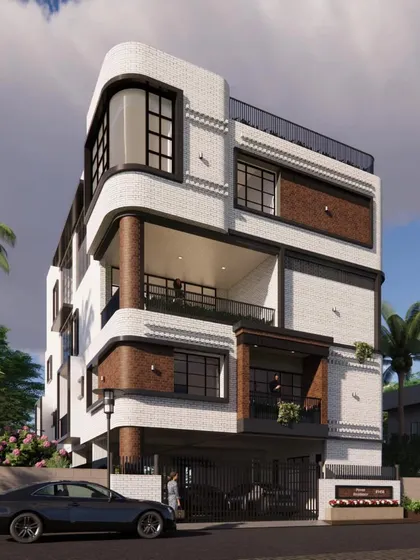 This modern villa in Anjanapura features striking Art Deco elements. The elevation is defined by bold white and red brick cladding, black Georgian window grills, and a unique curved bay window, creating a distinctive and stylish facade.
