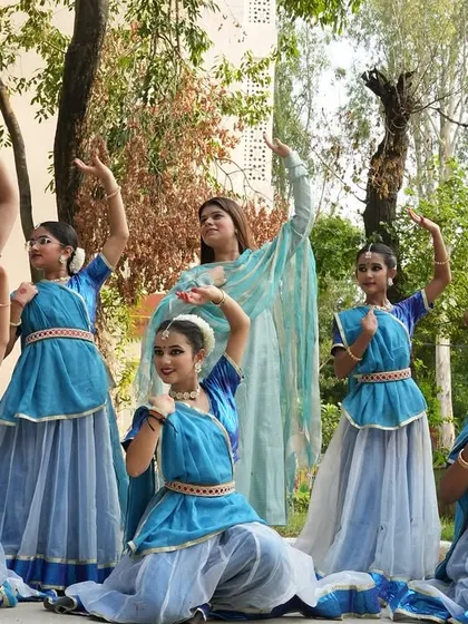 Here I am with a group of my students in their performance costumes. Seeing them ready to go on stage, filled with excitement and dedication, is a moment of great pride for me as their guru.