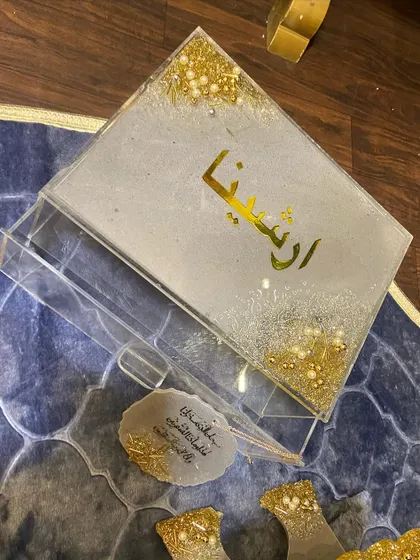 A top-down view of the personalized gift set, showing the Quran box, holder, and matching car hanging.
