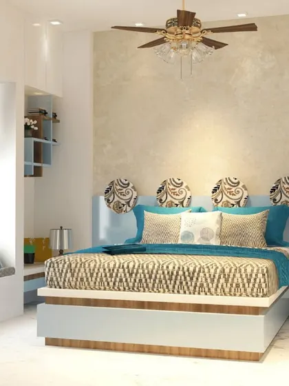 The bedroom in our 'Contemporary Fusion' project features a beautiful bay window seat, a unique headboard design, and a calming color palette of blue and beige, creating a perfect personal retreat.