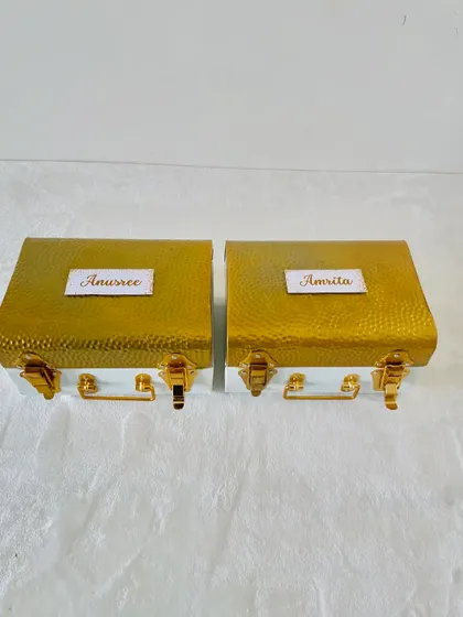 For a more personal touch, we can add individual nameplates to our premium metal trunks, as seen here with "Anusree" and "Amrita."