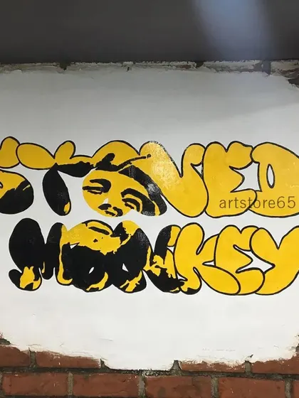 We painted this custom 'Stoned Monkey' graffiti logo directly onto an exposed brick wall for an ice cream parlor. This style of art adds a cool, urban vibe that matches the brand's identity.