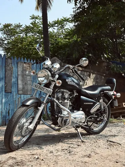 Another angle of the restored Thunderbird, showcasing its classic cruiser lines against a rustic backdrop.