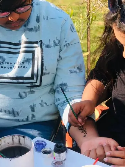 A client getting a custom music-themed temporary tattoo on their wrist. I can paint almost any design you can think of.