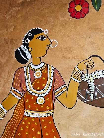 A close-up on a woman carrying a basket of flowers. The fine lines, bright colors, and traditional jewelry are all painted with precision to honor the Cheriyal art style.