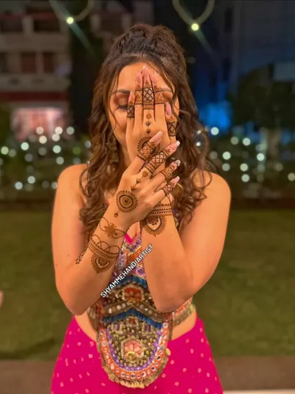 This is how my henna art looks on a happy client. I focus on creating designs that are not only beautiful up close but also complement your overall look for any occasion.