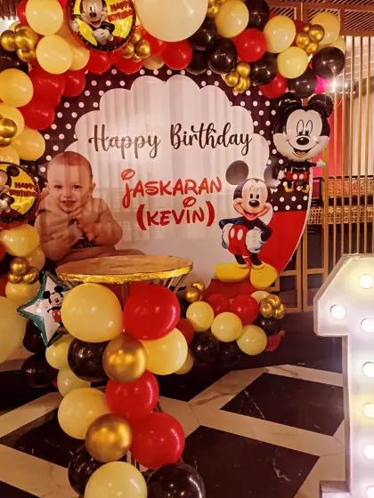 A first birthday is a precious moment, and I loved bringing this classic Mickey Mouse theme to life for little Jaskaran. The setup included a personalized backdrop, a full balloon arch in signature red, yellow, and black, and a light-up number '1' to make the celebration extra special.